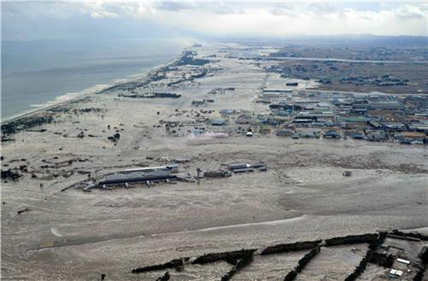 A view of the flooded Sendai Airport and coast after the tsunami. REUTERS/Kyodo