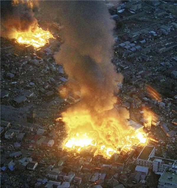 Buildings burn following an earthquake in Yamada town, Iwate Prefecture, northeastern Japan, March 11, 2011. REUTERS/YOMIURI
