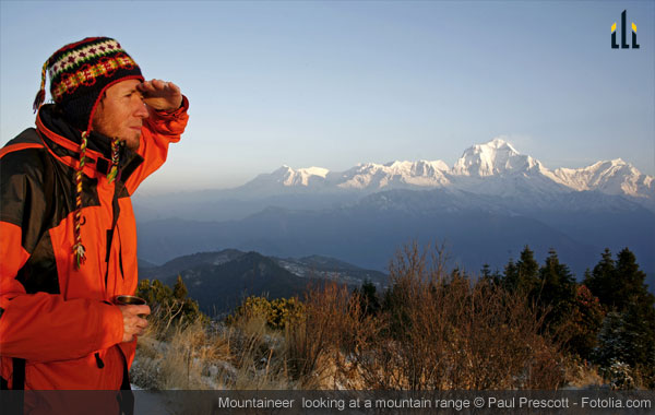 mountaineerer looking at a mountain range 