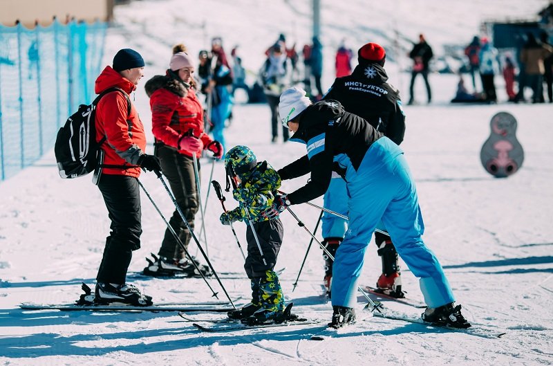 Arkhyz instructors help a new skier learn the ropes