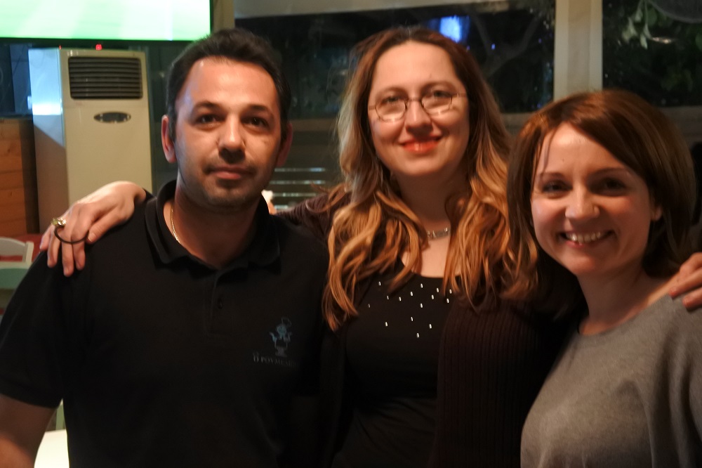 The tavern owner, Mihaela, and Yianna, and me behind the camera. 