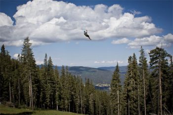 Almost reaching the clouds along the highest elevation zipline in the United States at Angel Fire Resort.