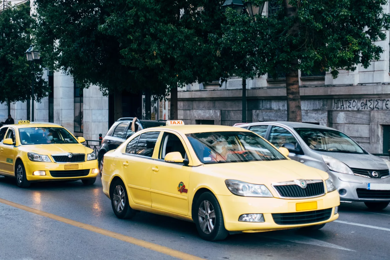 Greek taxi drivers in cabs.