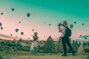 Man photographing hot air balloons in Cappadocia.