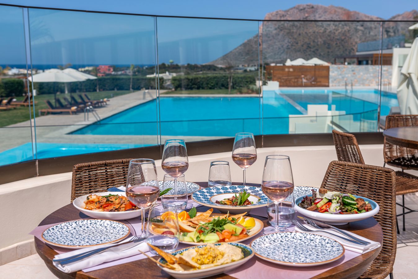 Isla Brown Chania Resort lunch by the pool with a view of the sea and mountains. 