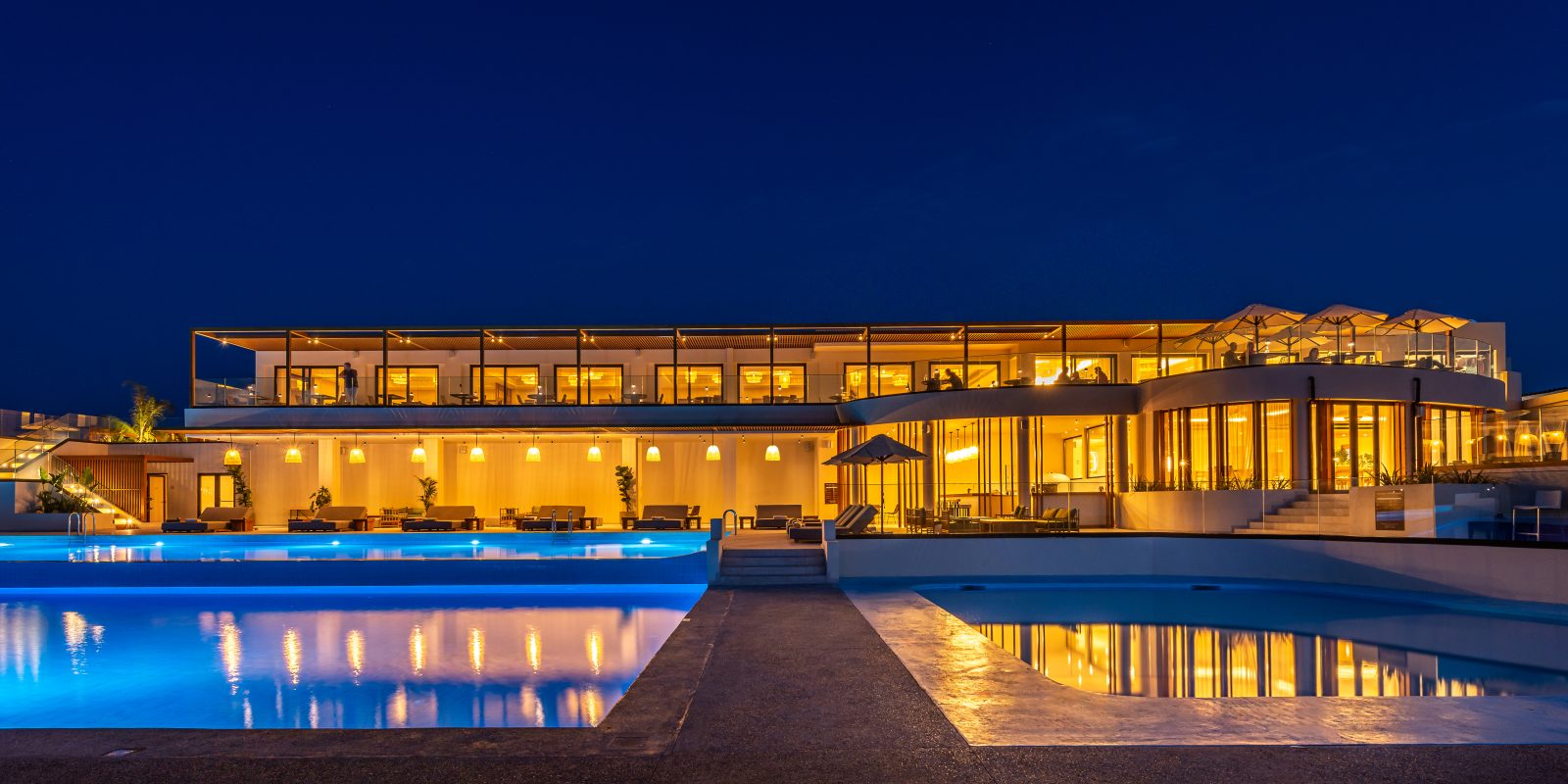Isla Brown Chania Resort with main pool at night.