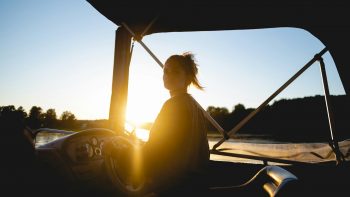 woman in black shirt sitting on chair during sunset