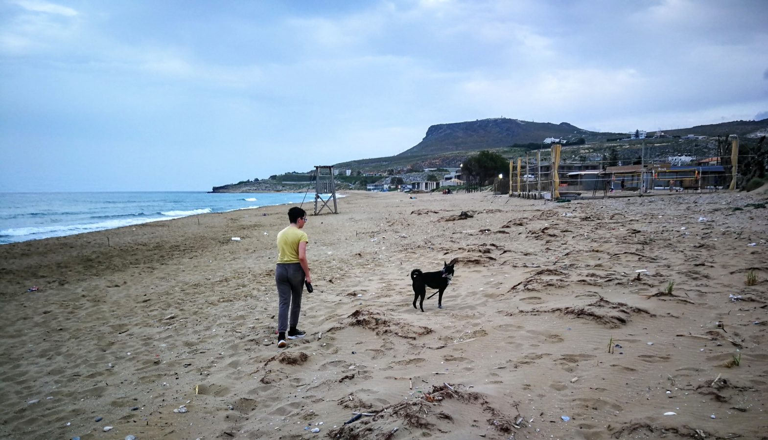 Paul-Jules with Mojito on a quiet Cretan shore — boy and hound, bound by sun and sea.