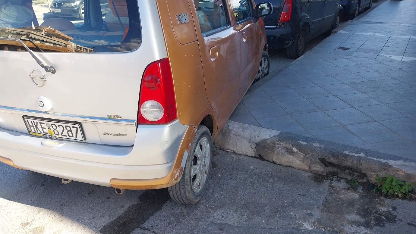 how did he manage to park OVER the curve and sidewalk