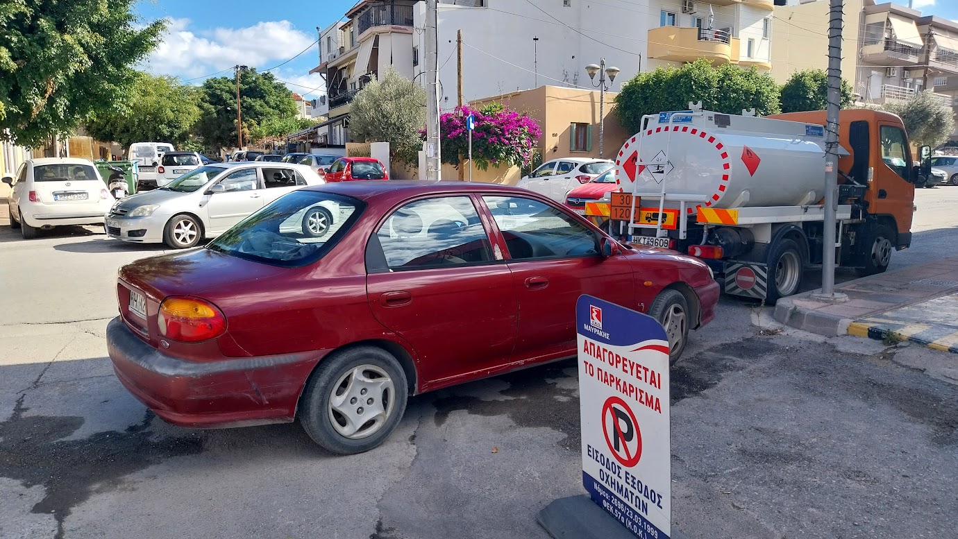 parked in ther curve behind truck transporting hazardous materials near a no parking sign